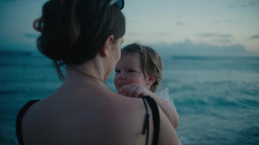 The view is of a portrait of a mother and her child at the beach