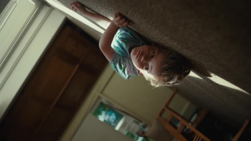 Angled shot of a toddler boy laying on the floor