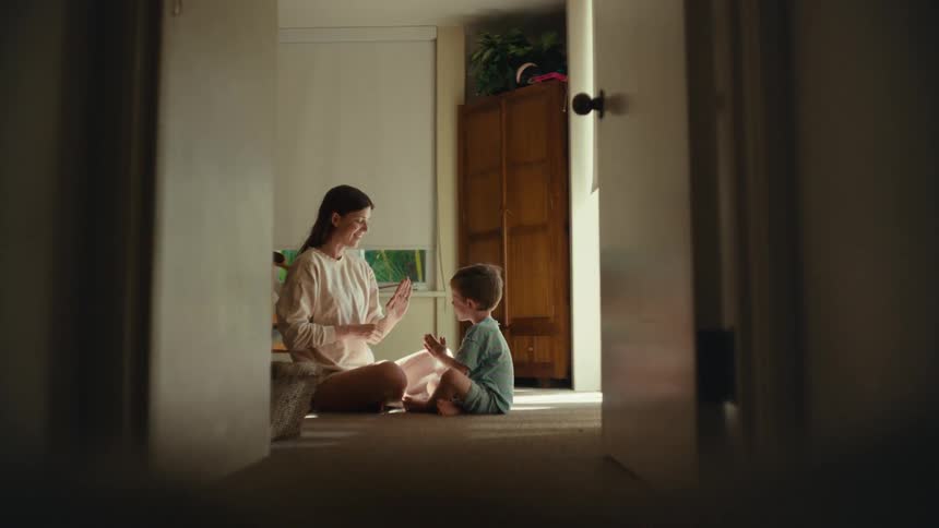 A mother and son sit and play