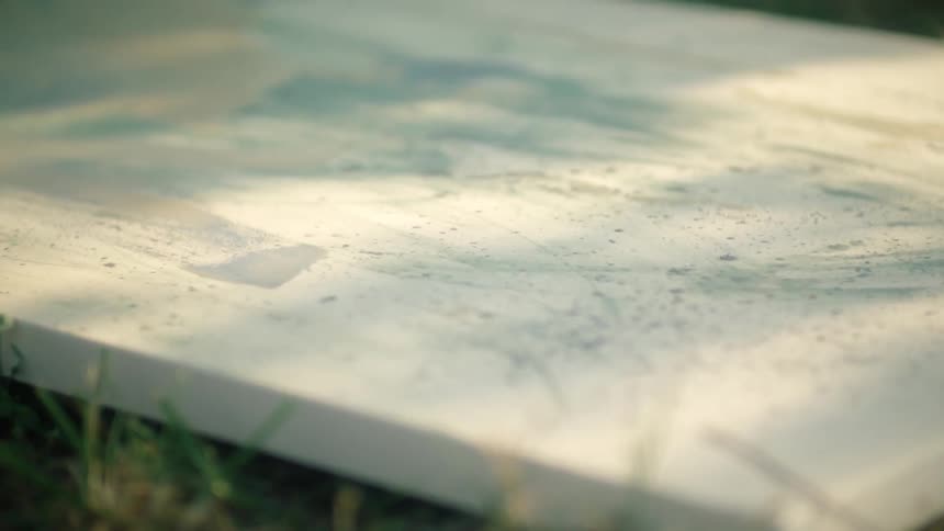 Close up of big canvas laying on green lawn