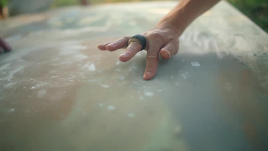 Two people are painting on the canvas