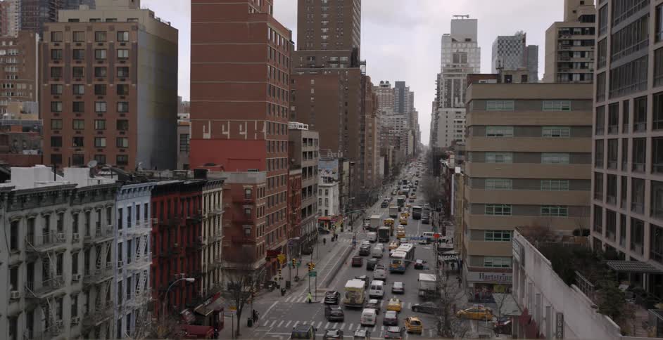 Cars and buses slowly traveling down a city street