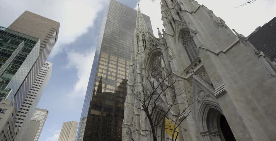 A cathedral sitting among tall buildings in a city
