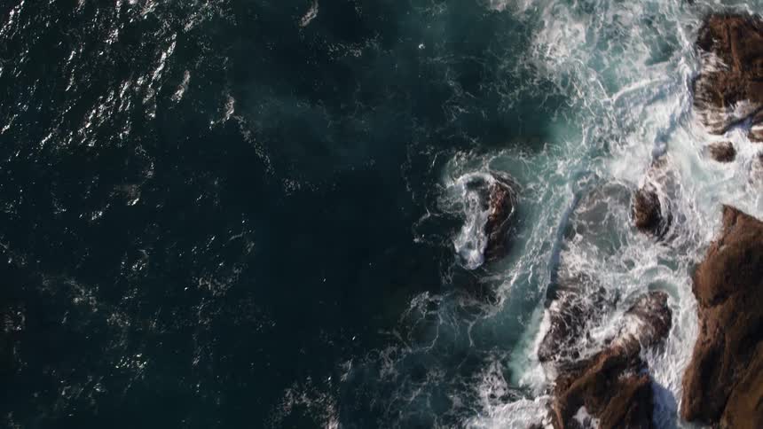 Top down drone footage of waves crashing in Big Sur