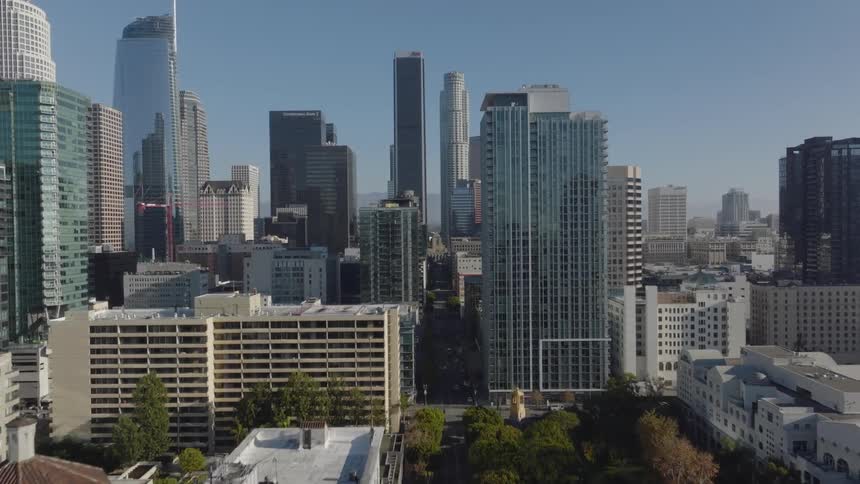 Downtown skyscrapers reflect neighboring buildings and the sky