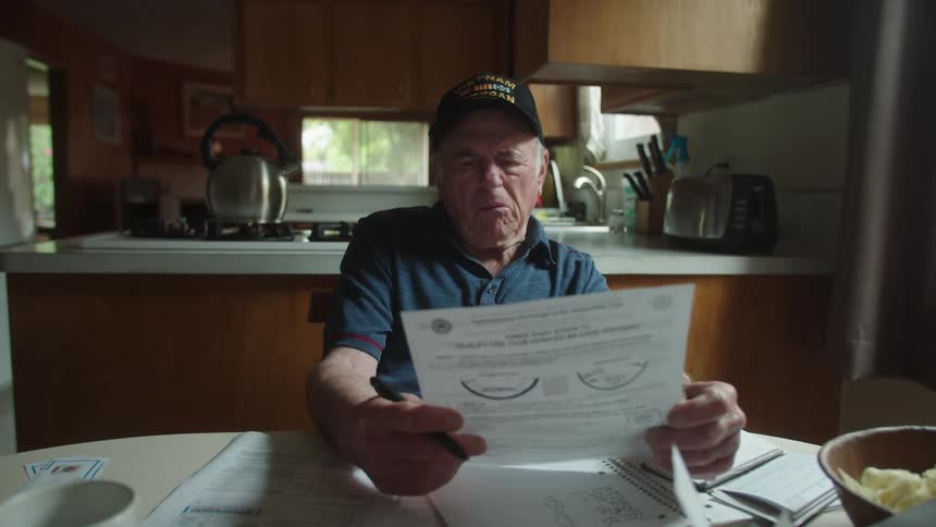 A man is confused as he fills out paperwork