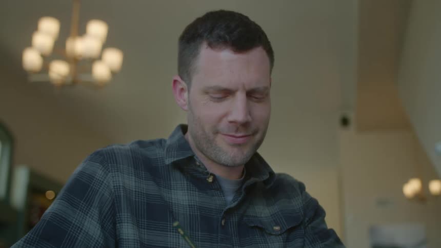 Man sketching with drawing pencil nods to person he is talking with