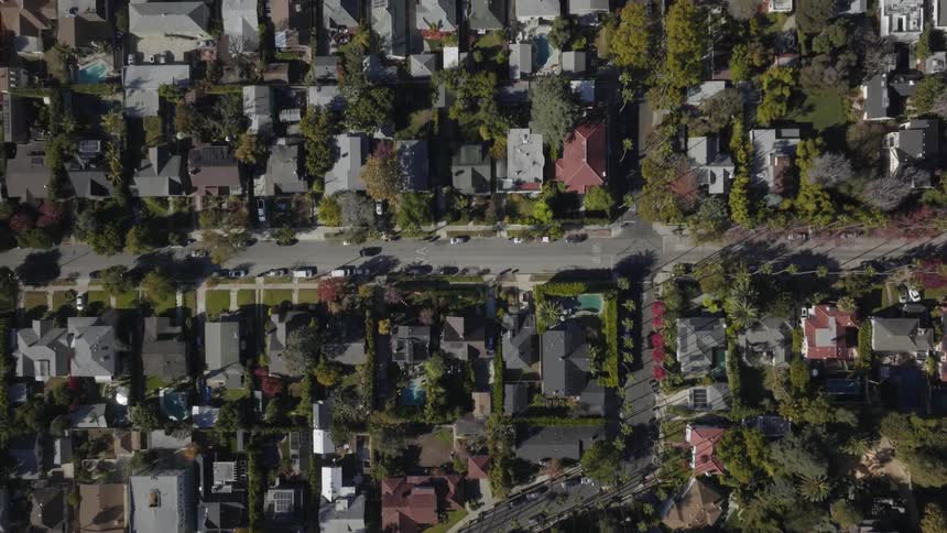 Vehicles move along streets through residential neighborhood