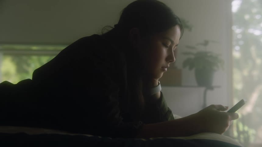 A woman using a smartphone in a room