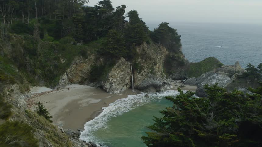 The water crashes against the shore