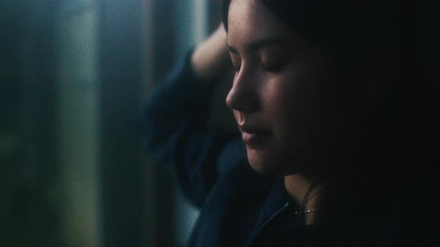 A woman sitting in a room stretching