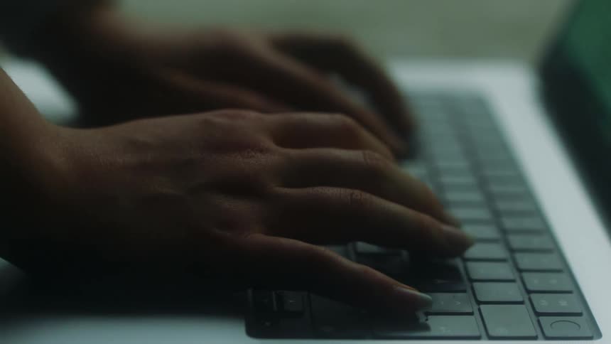 The view is of someone that is typing on there laptop
