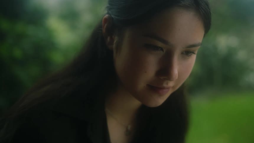 Woman looks up from task with a smile