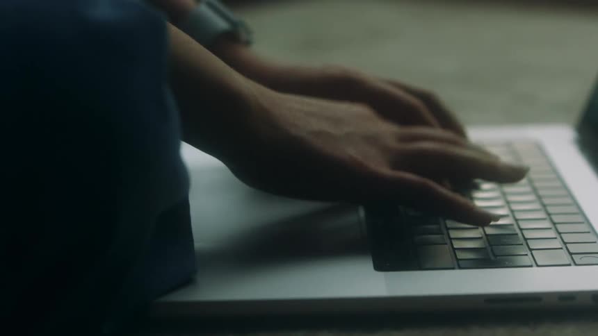 A woman typing on a laptop