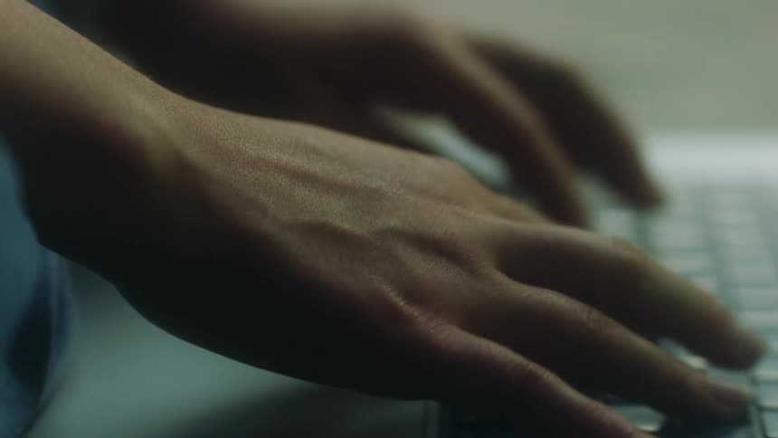 A person is typing on a laptop