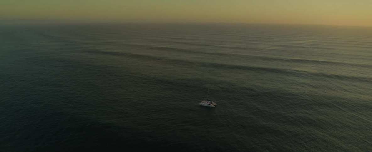 A large boat on the open ocean in the evening