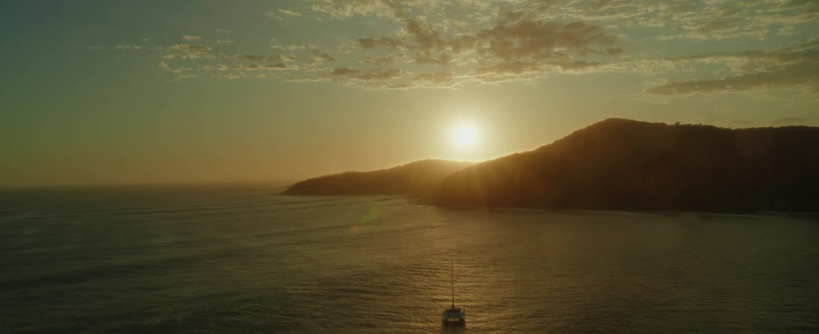 The sun is rising by the island