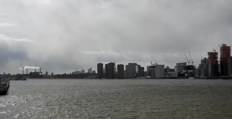 Heavy clouds are over the city across the water