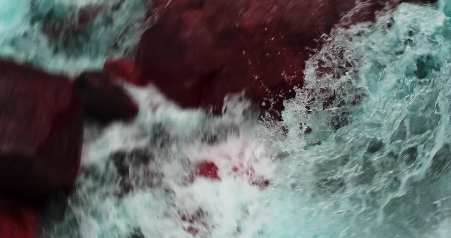 The water crashes against the rocks