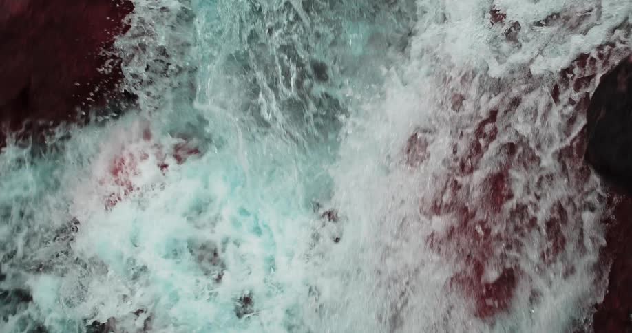 Colored filter tints boulders around falling water red