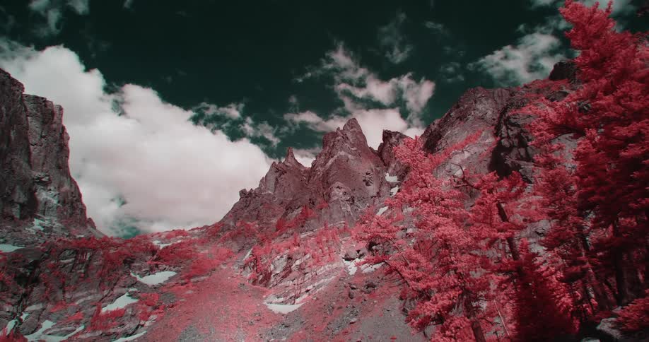 Colored filter tints forest and snow dabbed mountains red