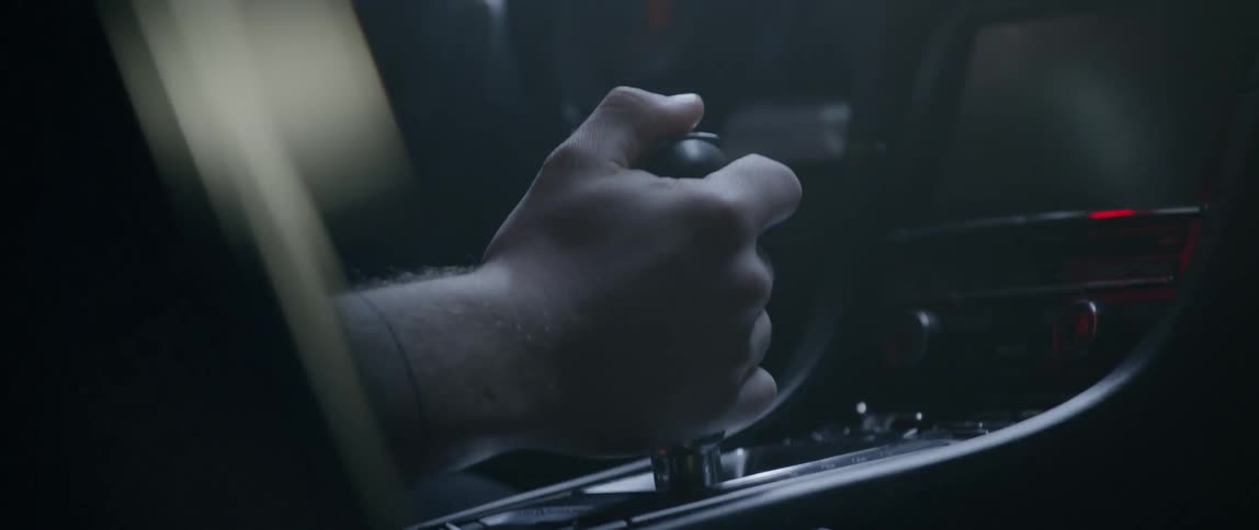 A hand changing the gear of the vehicle