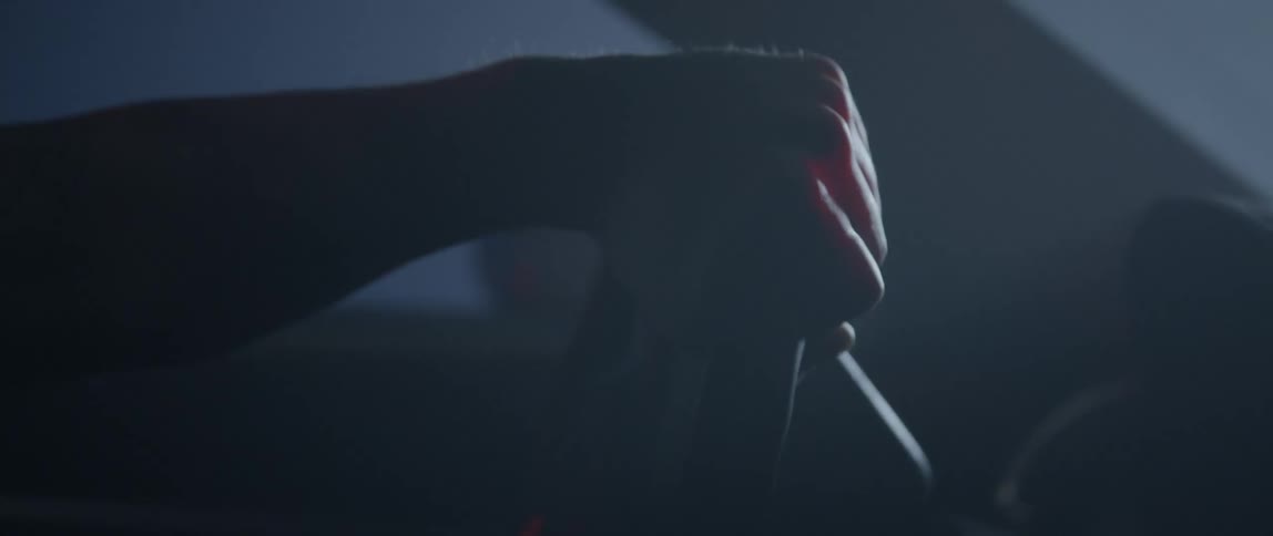 A person is driving in the dark