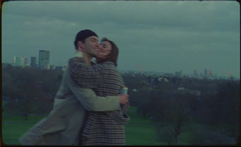 A couple hug and kiss in the park