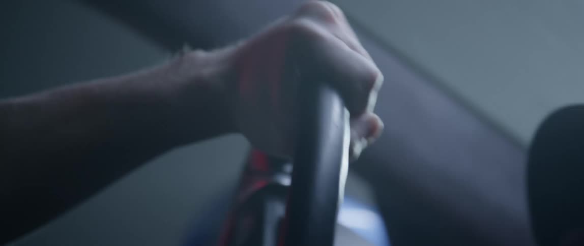 A man turning the steering wheel very hard at high speed