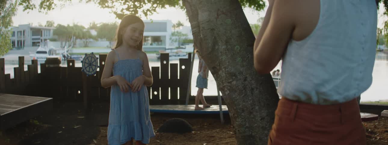 Mother is taking pictures of her daughter outdoors in the day time