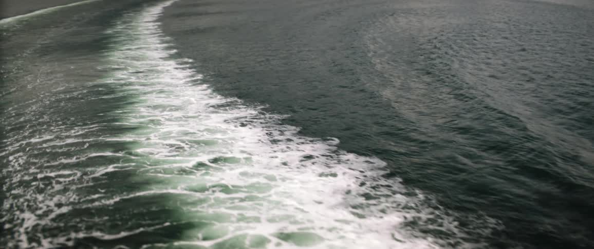 The wake behind a boat and the waves extending from it