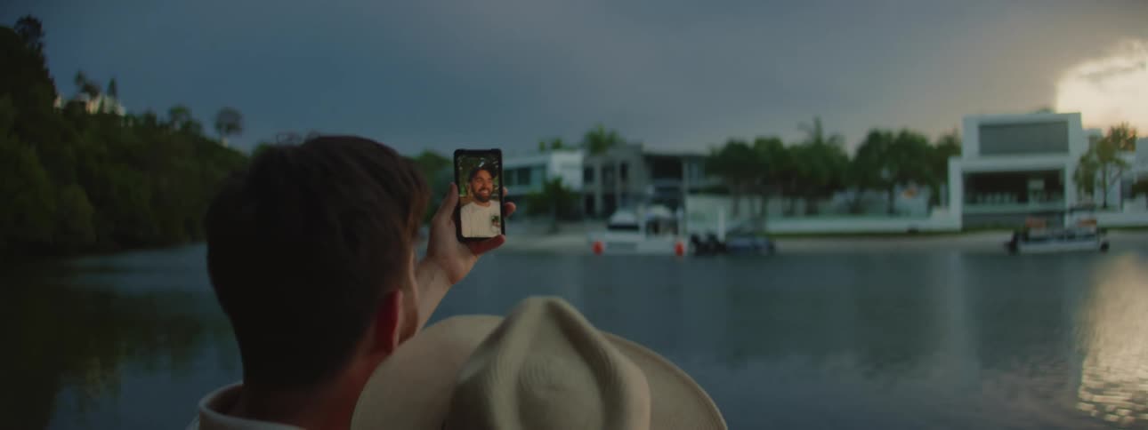 A couple on a video call by the water