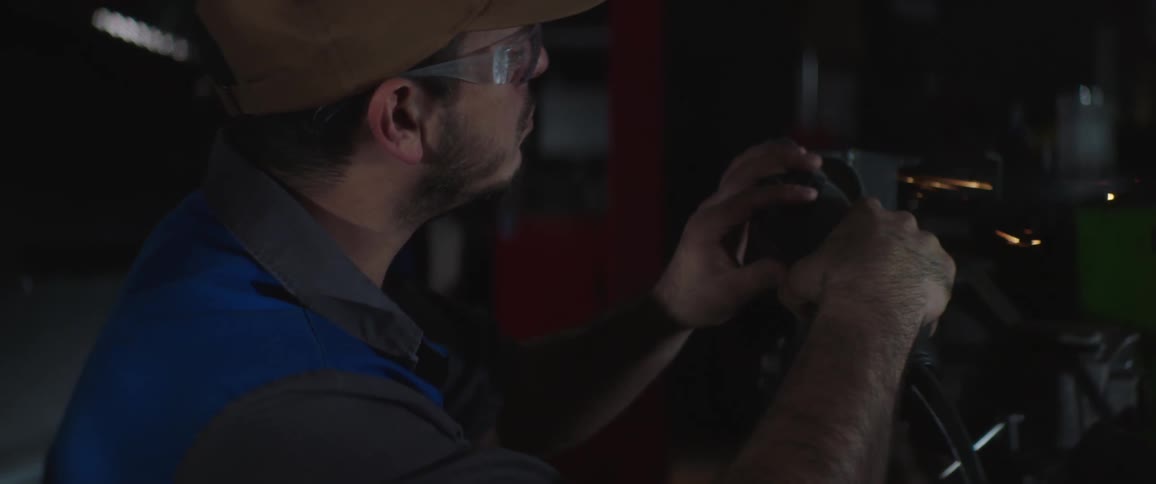 A man is working on his car during the night