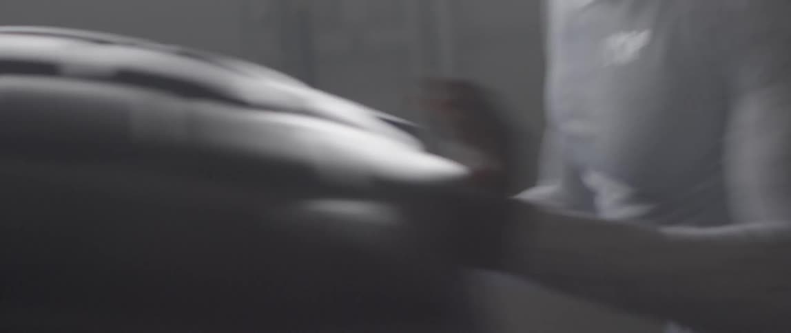 A man is pushing a huge tire