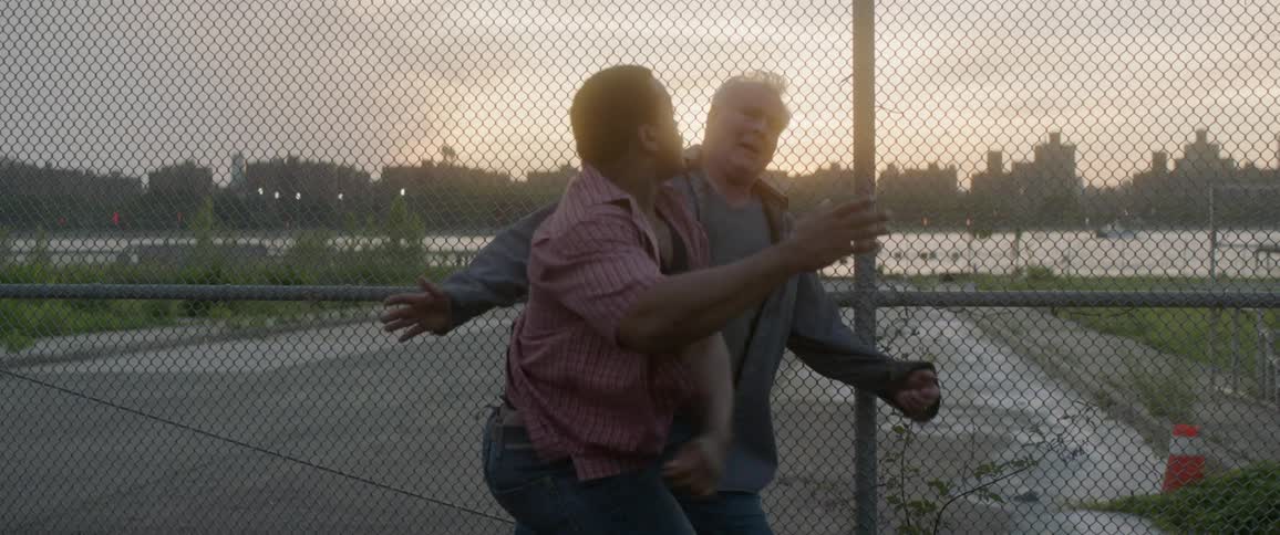 A man punches an older man in the stomach and then in the face