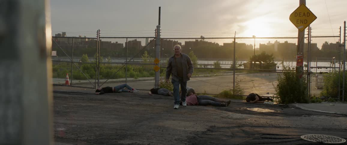 Old man walking away at sunset after beating five other people