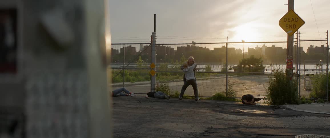 Two men fight outside of the fence