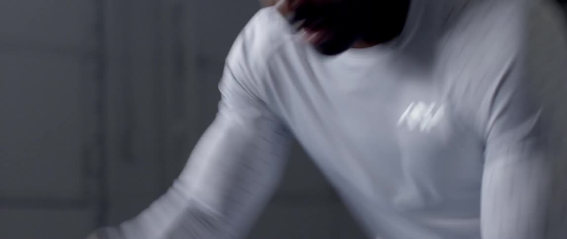 A man is pulling on ropes up and down exercising