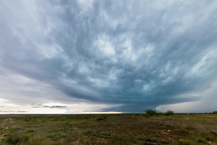 Storm clouds form over a field