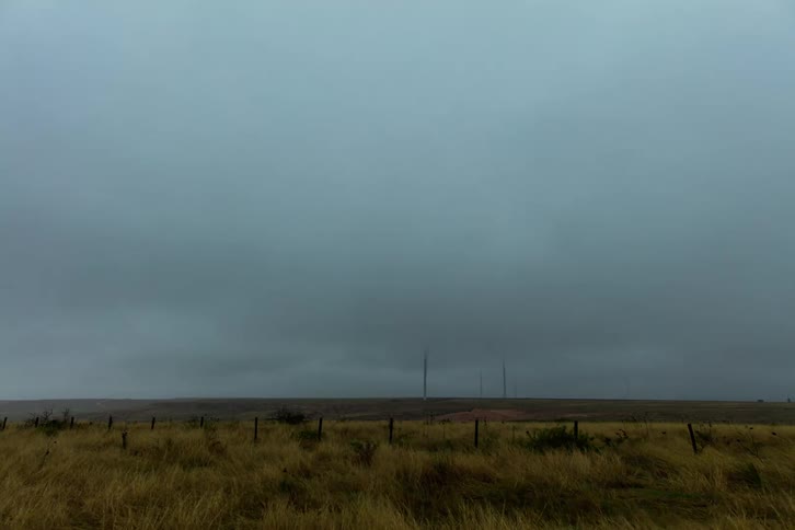 Timelapse of storm clouds passing over a wide open grassland