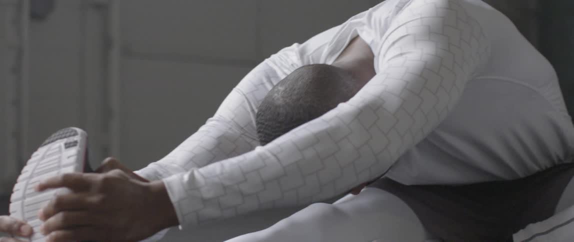 A man is stretching in a gym