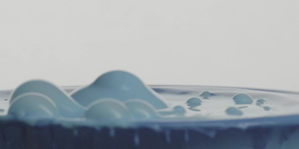 The blue paint bubbles in the container