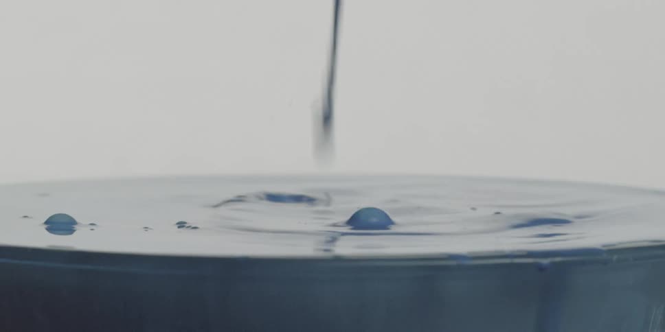 A thick liquid is being poured into a pot