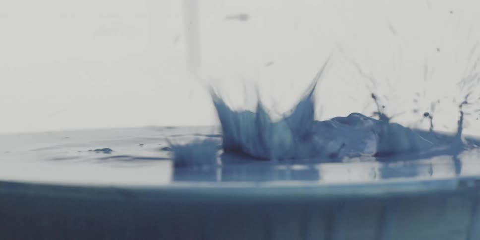 A thick substance is splashing in a puddle
