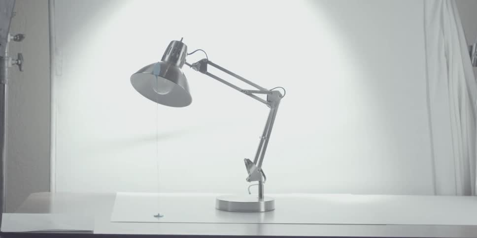 Lamp on a table with bulb shining brightly