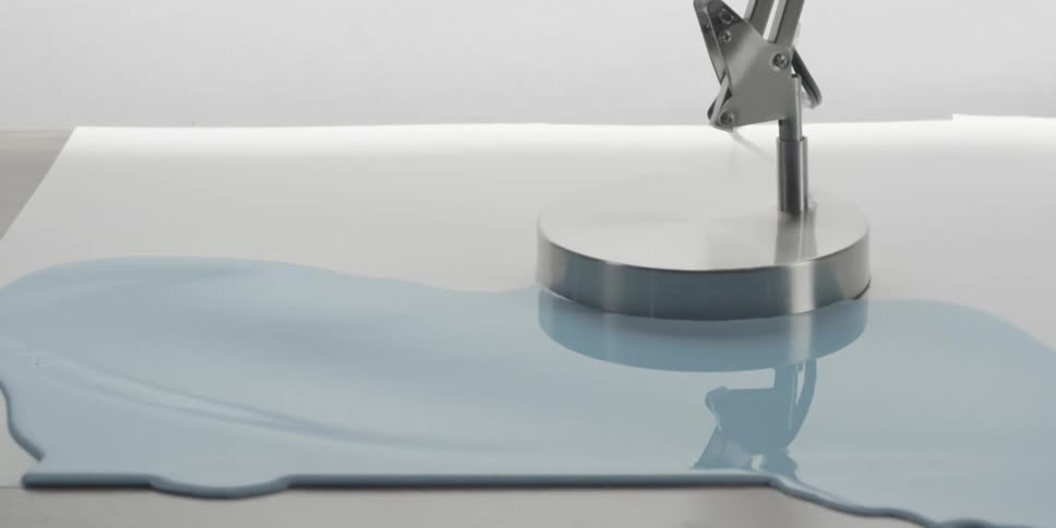 Paint flows around a lamp base
