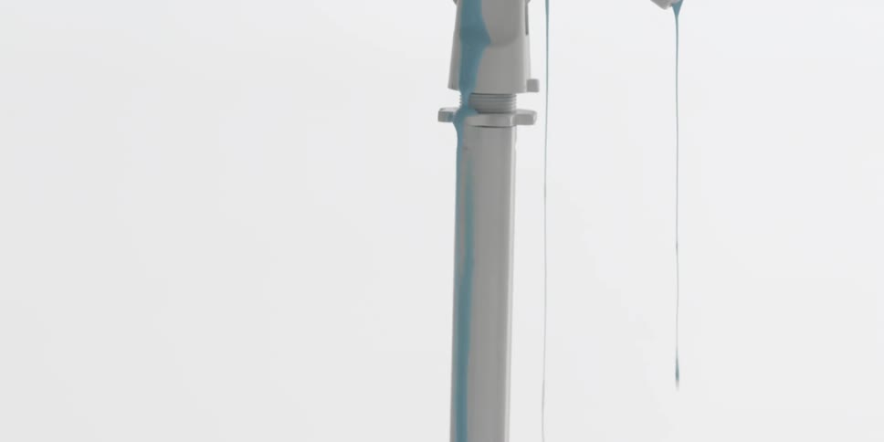 Blue paint drips down a white pole