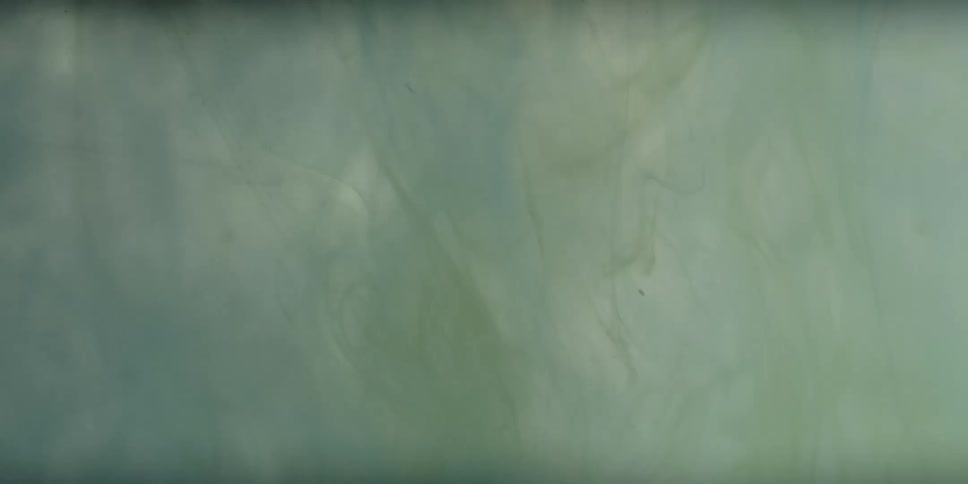 The liquid has white paint swirling around