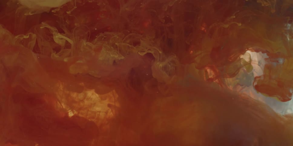 Colors and light blend as liquid drifts in abstract