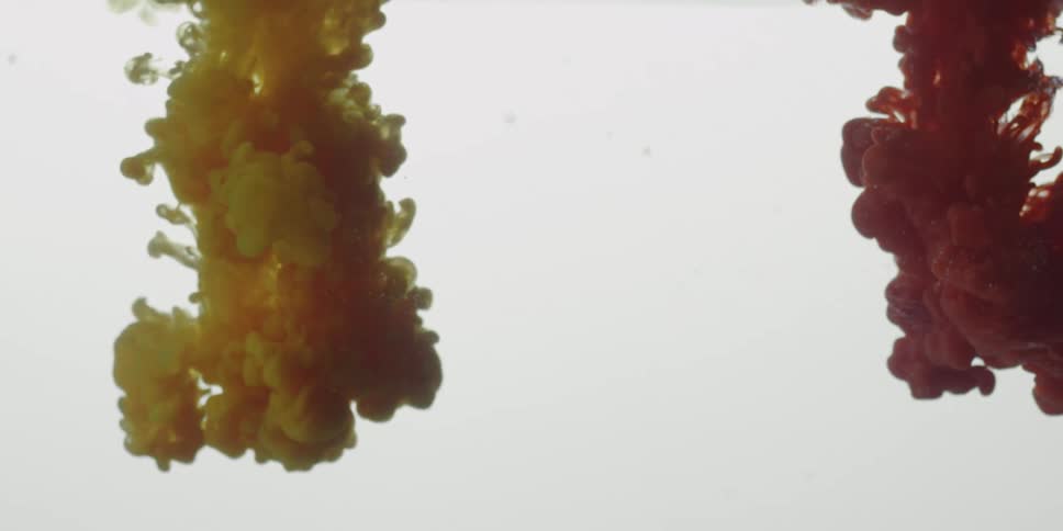 Colored liquid is poured into clear water